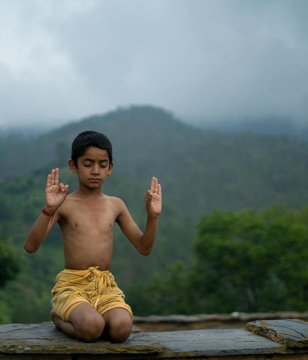 Woman in a calm state practicing conscious breathing in a serene environment.